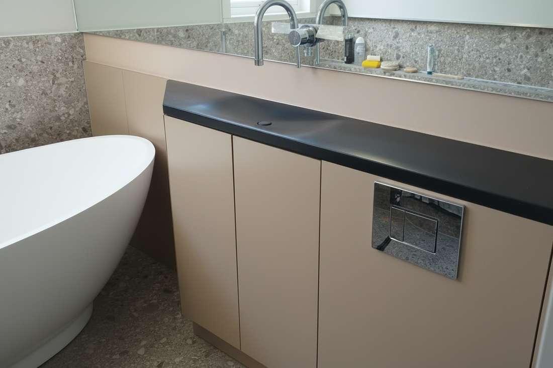 A bespoke black concrete vanity top with infinity sink. The custom shape allows it to seamlessly into the bathoom shape for maximising space 
