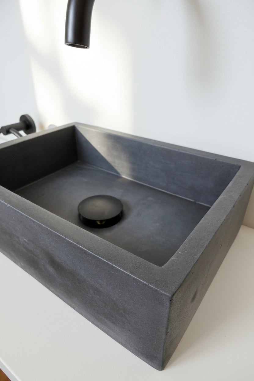 close up of black concrete MINI sink, angled view
