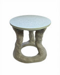A round side table with a exposed aggregate light gray concrete top and a sculptural, tree-like concrete base in a weathered gray finish, shown on a white background.