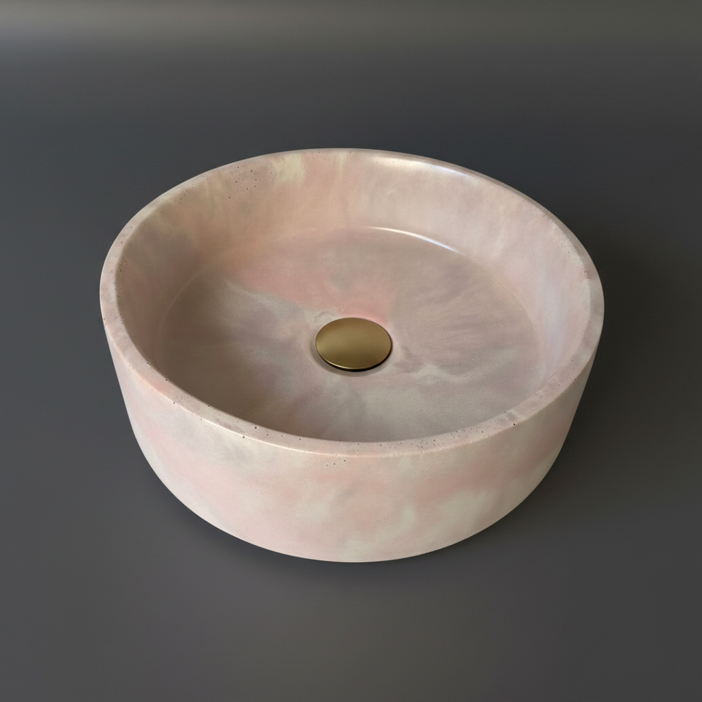 Round bathroom concrete sink by nedevdesign, marble effect finish, soft flowing colour variation, combination of pink, ivory and soft brown shades. with brushed brass waste
