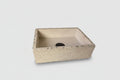 Concrete sink with exposed aggregate edge and rough exterior on white background