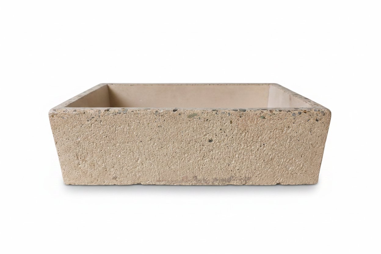 Rectangular concrete sink with rough  exterior finish and polished edge on a white background