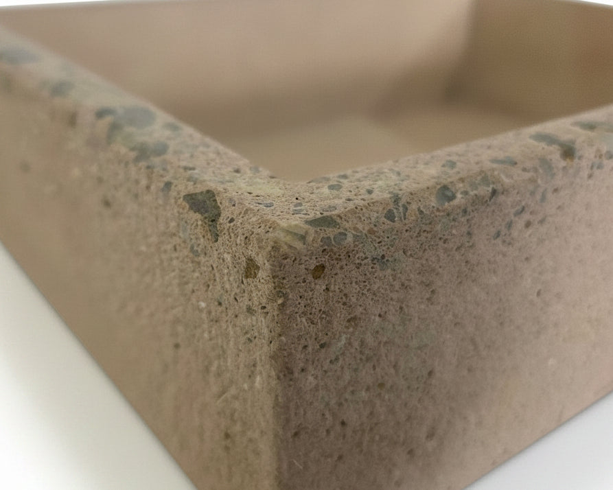Edge details of exposed aggregate and rough exterior concrete sink finish