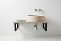 Pink concrete LAI basin on a concrete shelf supported by black steel rectangular brackets