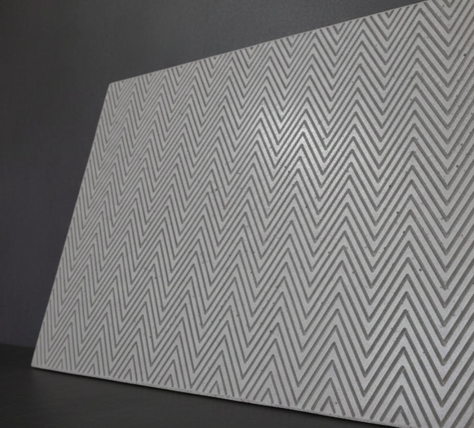 close up of grey concrete panel, chevron detail, splashback, wall mounting or as all art