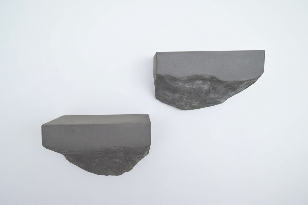 Two gray microcement shelves on a white background