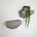 Set of two microcement wall shelves mounted on white wall with black brackets