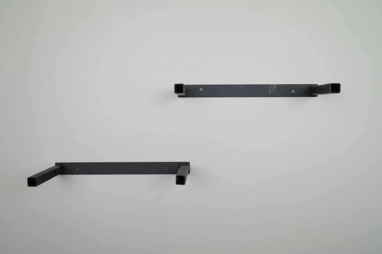 Detail of black mild steel wall mounting bracket for concrete shelf