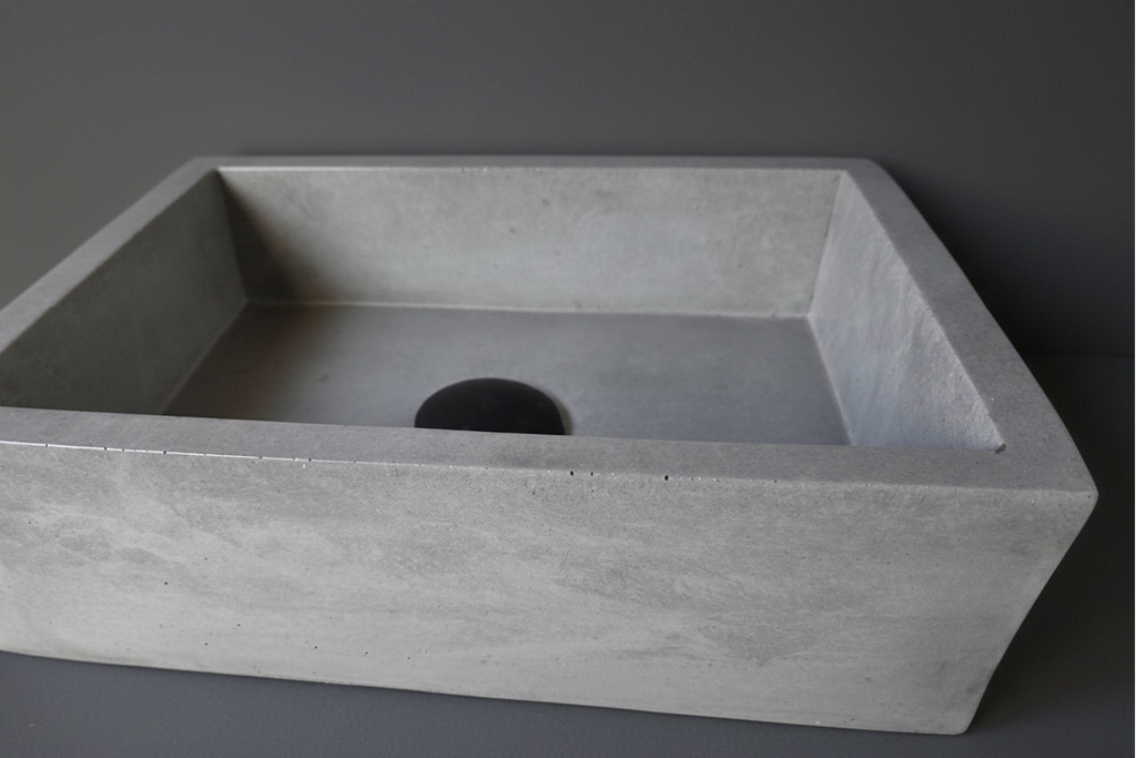 Rectangular concrete sink on a gray background