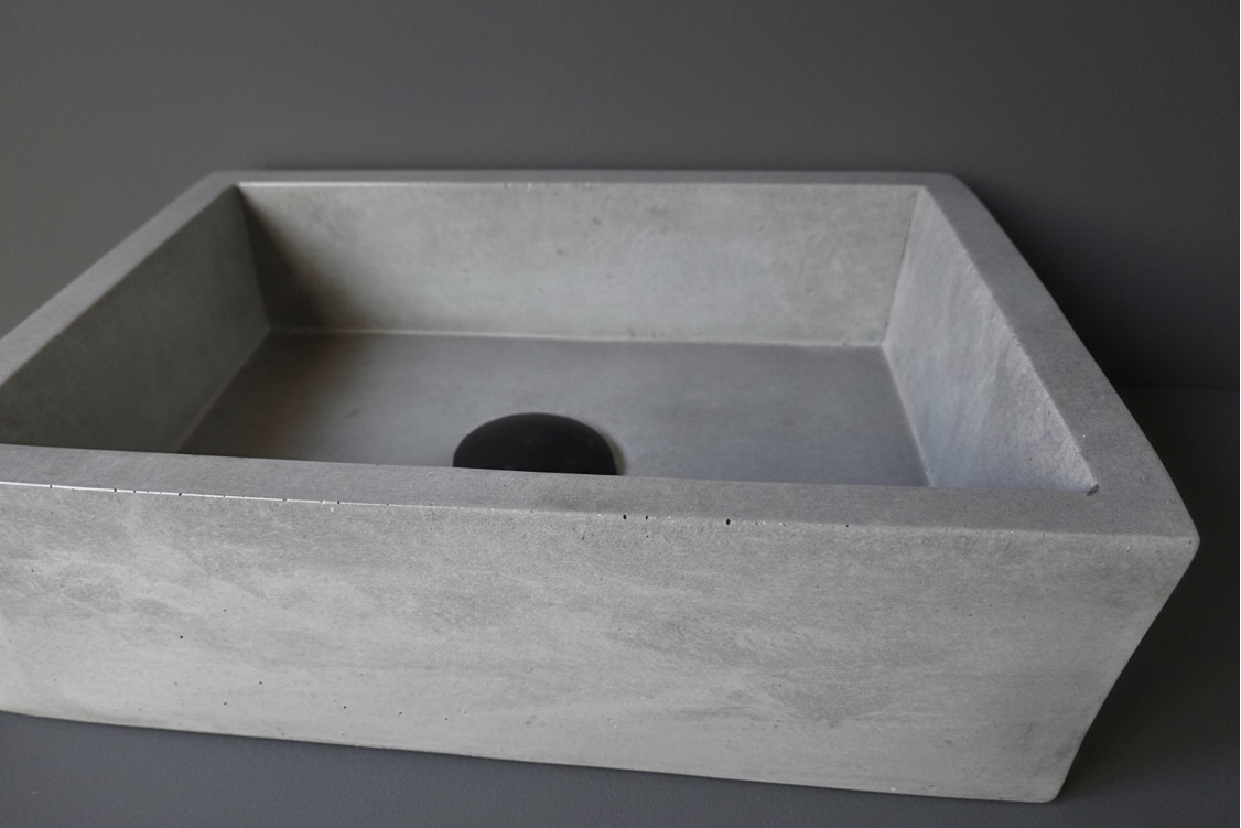 Rectangular concrete sink on a gray background