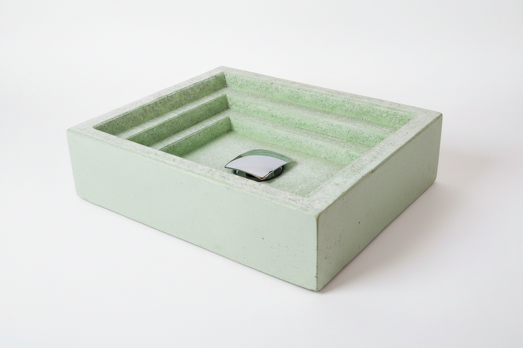 Green concrete bathroom sink with a textured surface on a white background