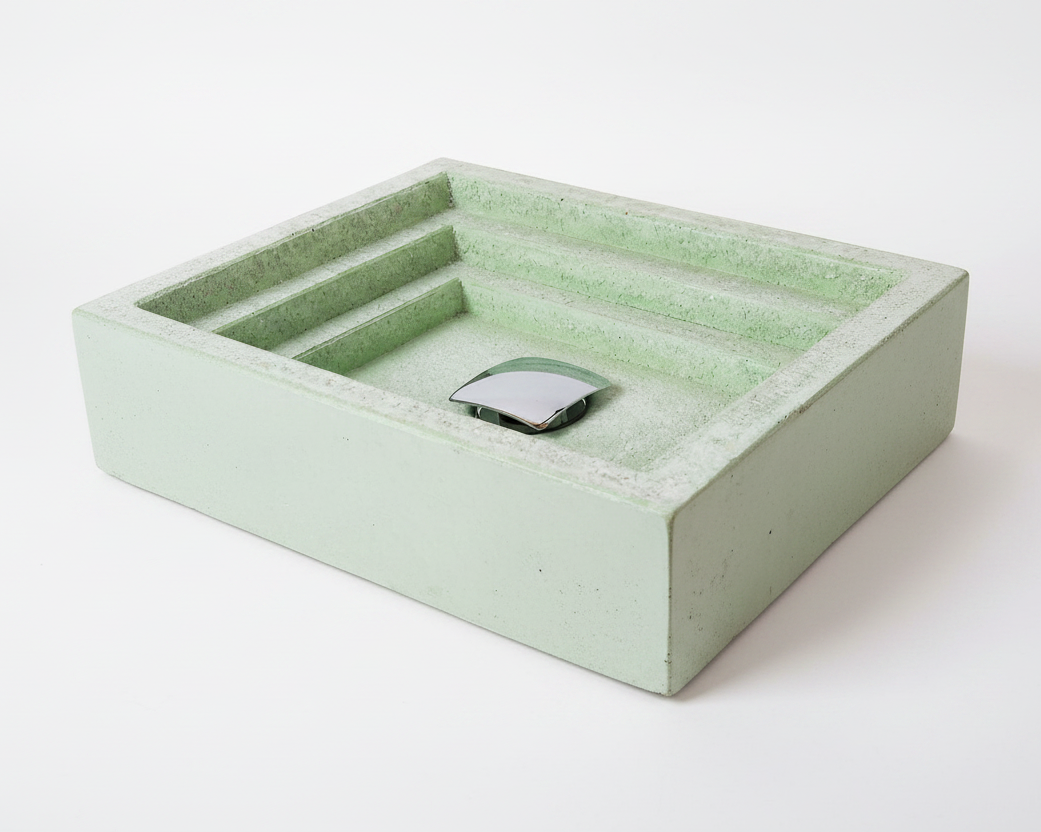 Green concrete bathroom sink with a textured surface on a white background