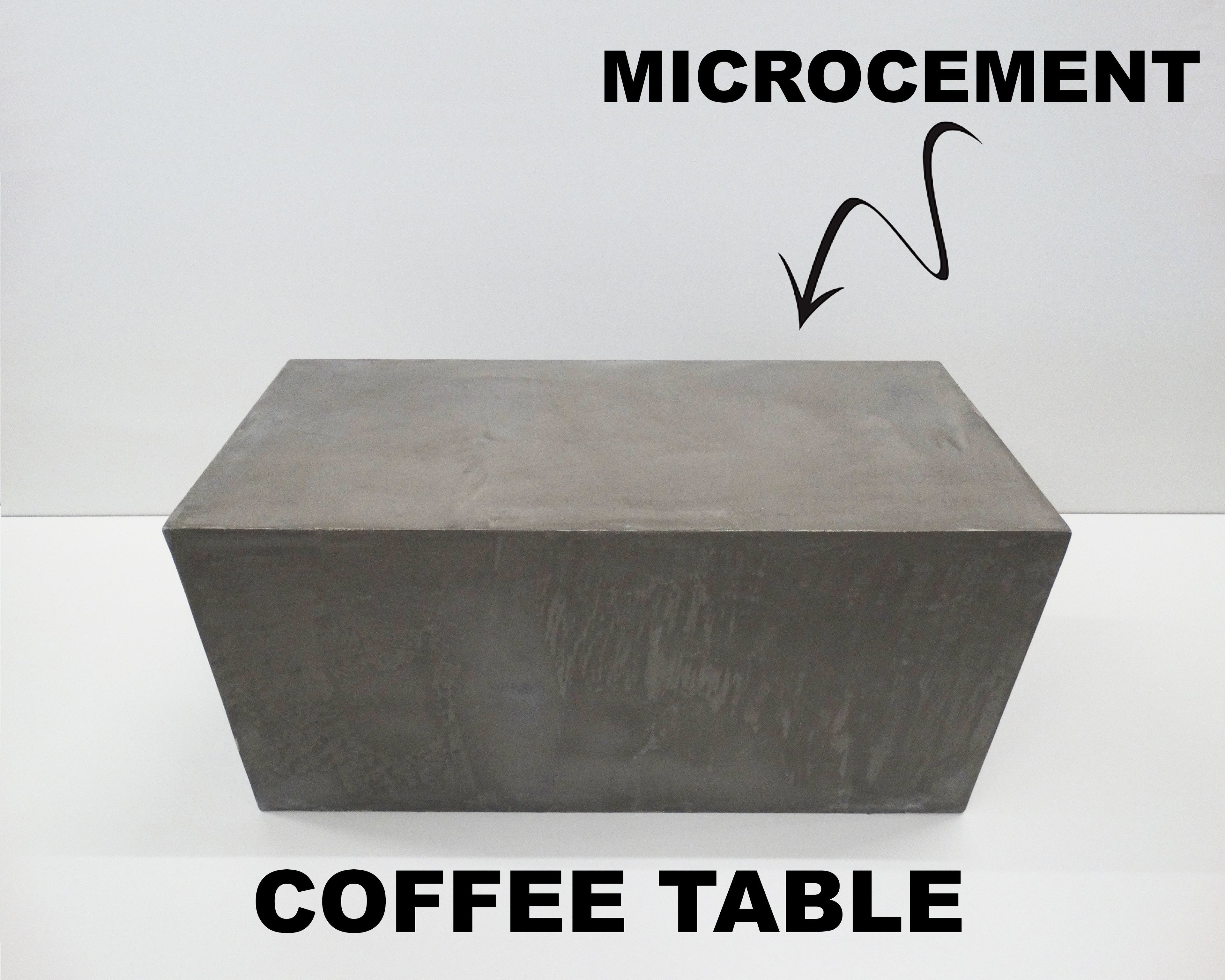 Front view of a grey rectangular microcement coffee table with a solid block design and clean minimalist lines.