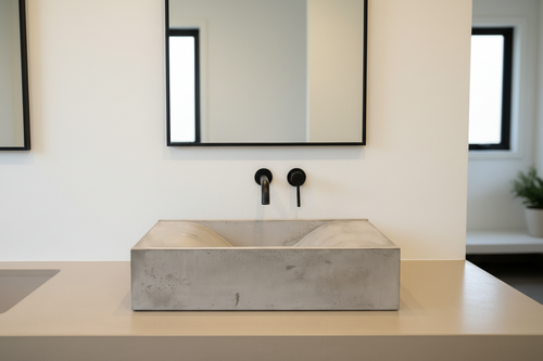 countertop mounted concrete sink in grey with sloped internal shape